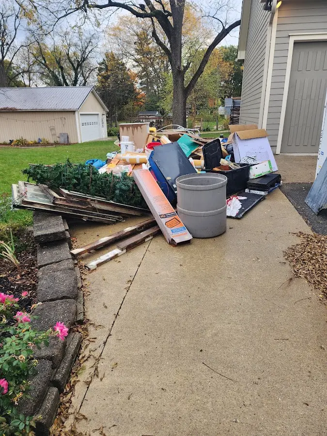 Dumpster being loaded with debris for 3 Yard Dumpster Rental in Tuscumbia